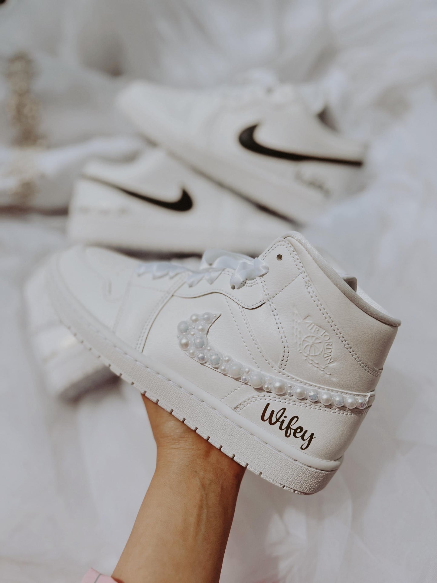 Close-up of women’s Air Jordan Mid wedding sneakers with pearl embellishments for brides