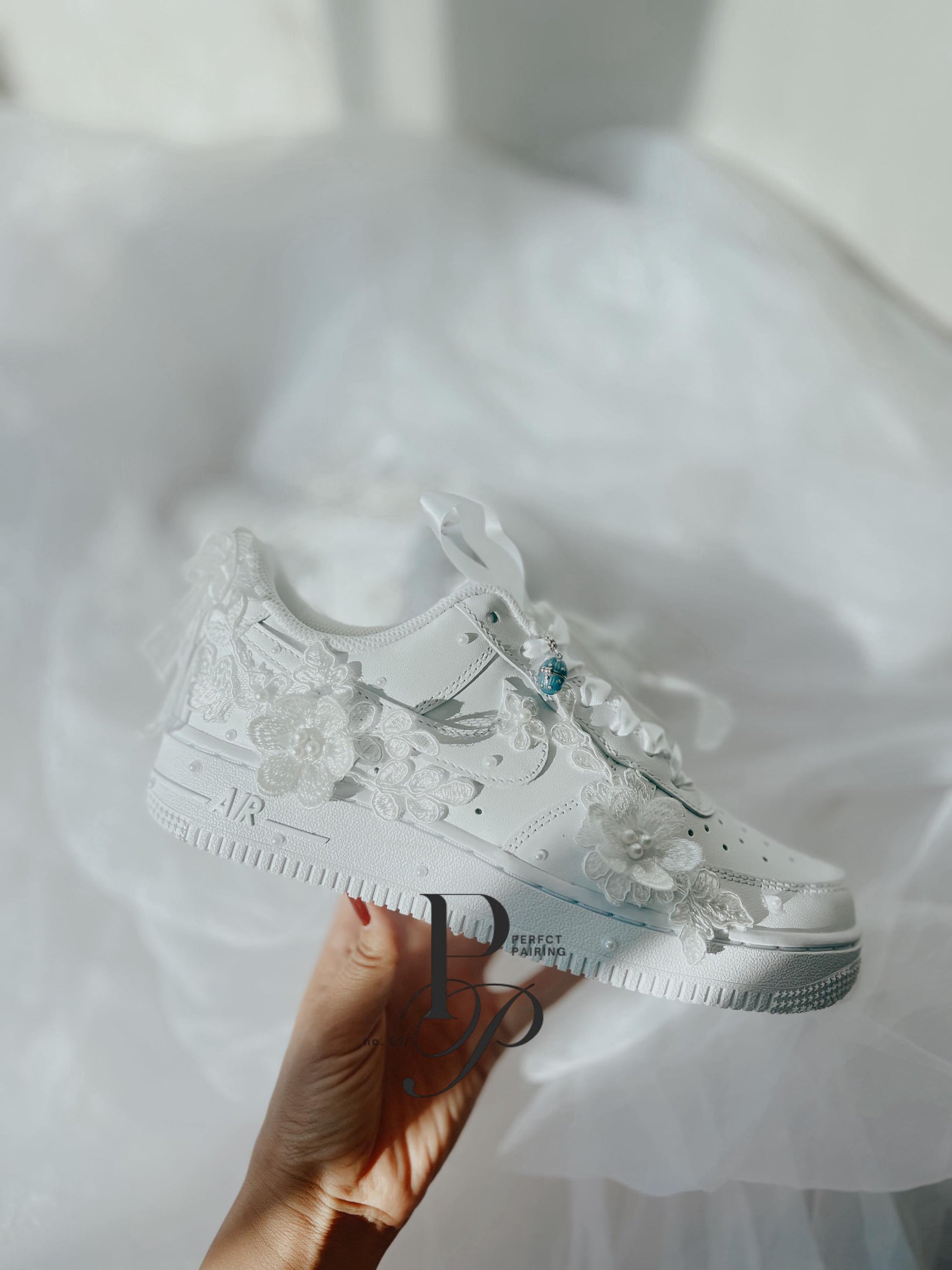 Elegant embroidered bridal sneakers styled in a soft wedding flat lay, perfect for destination weddings and receptions.