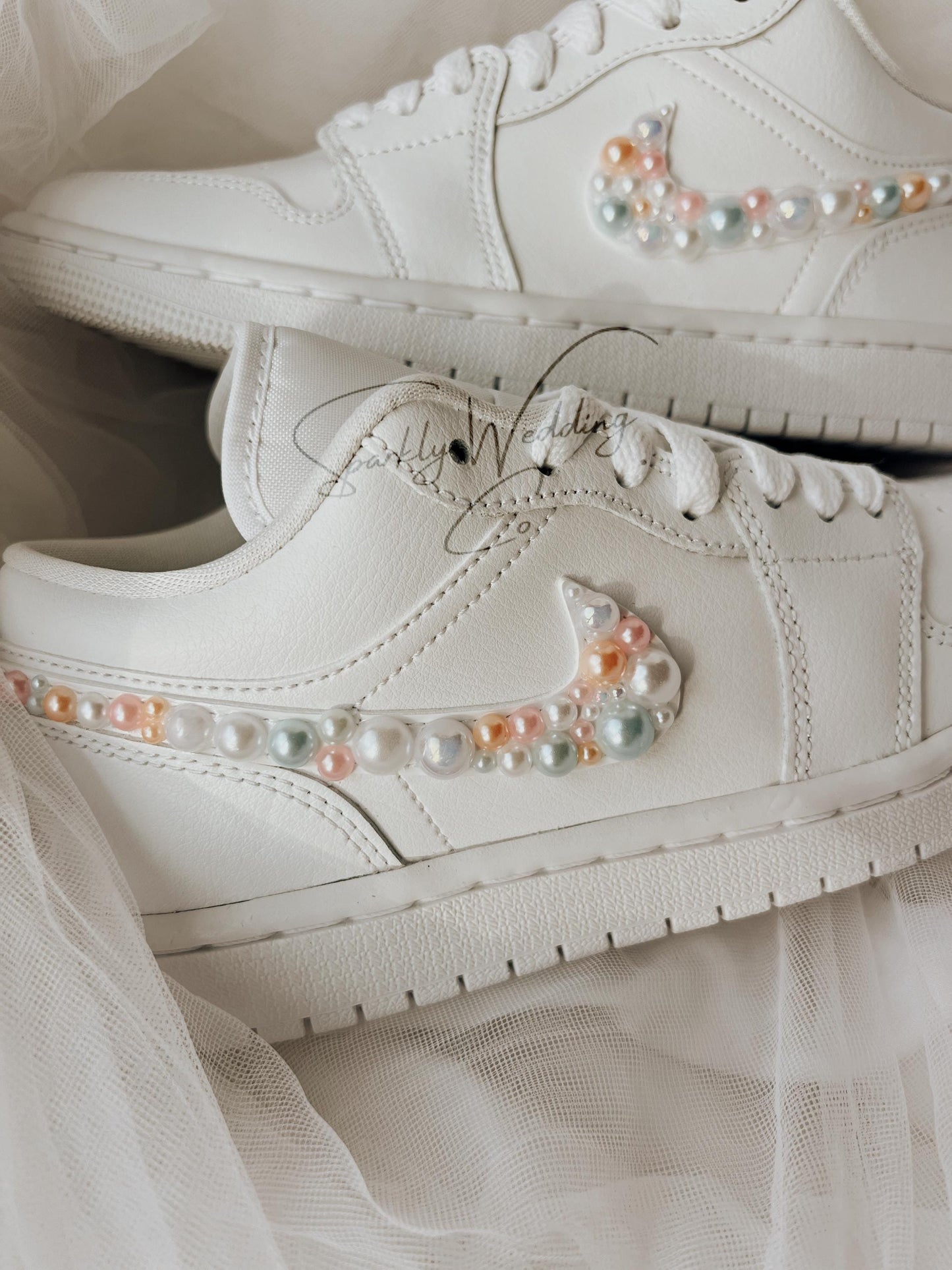 Close-up of pearl embellishments on custom Nike Air Jordan Low wedding sneakers for brides.