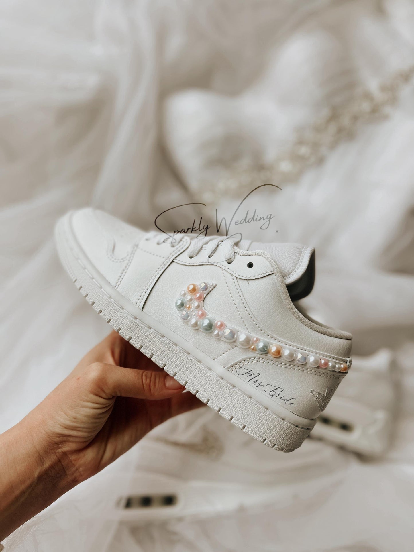 Side view of white Nike Air Jordan Low wedding sneakers featuring hand-applied pearls for a bride’s special day.