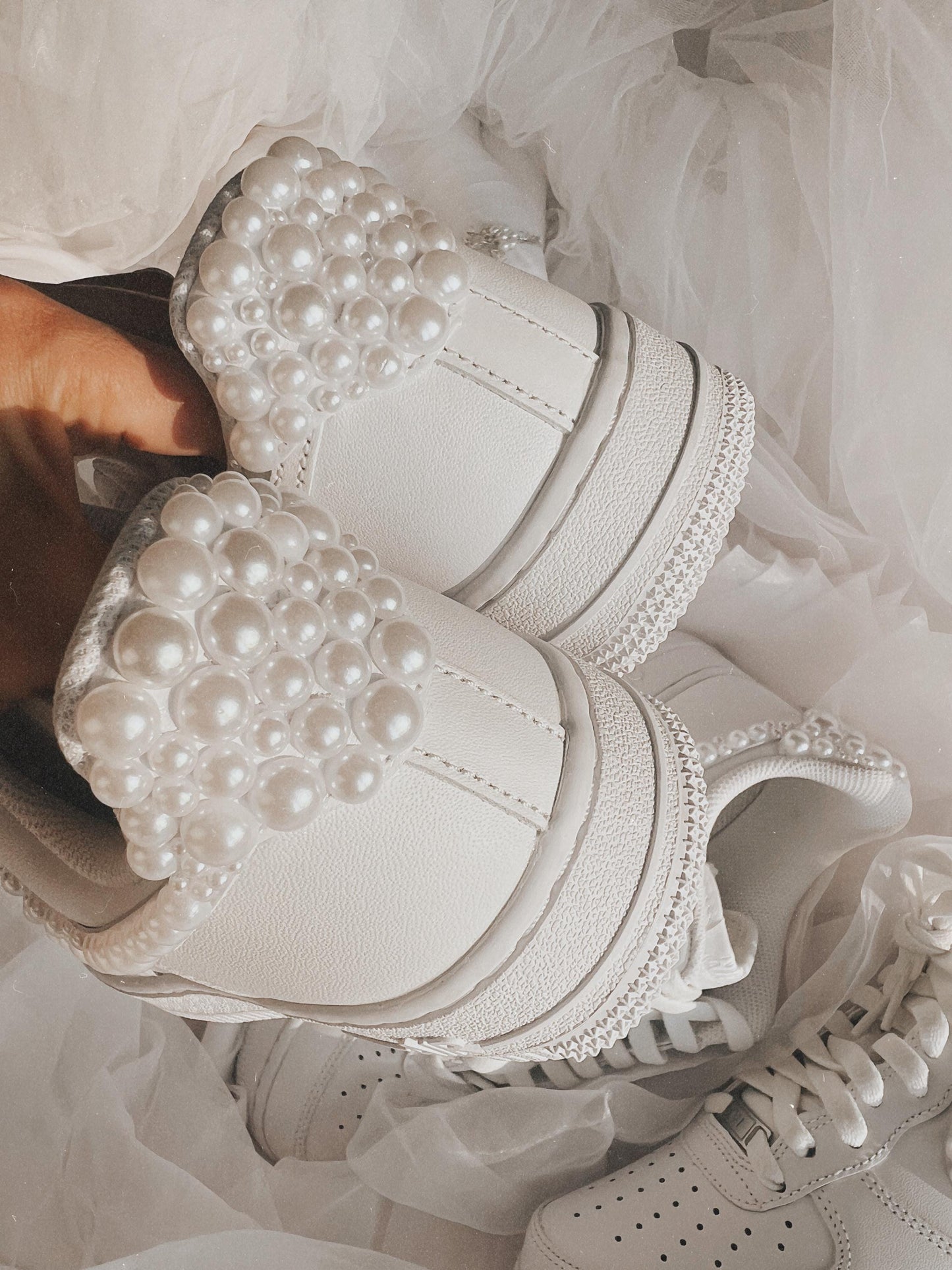 Back view of custom white pearl wedding sneakers with pearl details on the heel
