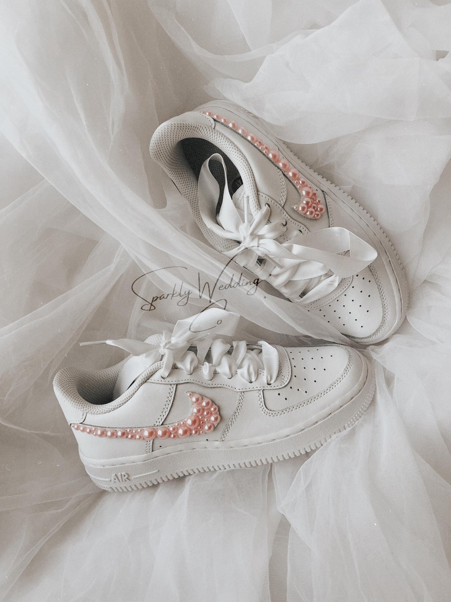 Custom pink pearl wedding sneakers for bride with pearl details on the outer swooshes
