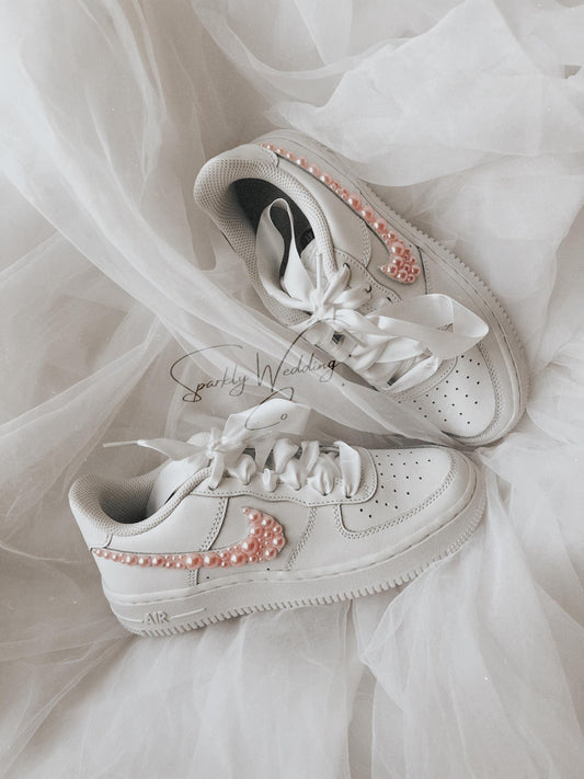 Custom pink pearl wedding sneakers for bride with pearl details on the outer swooshes
