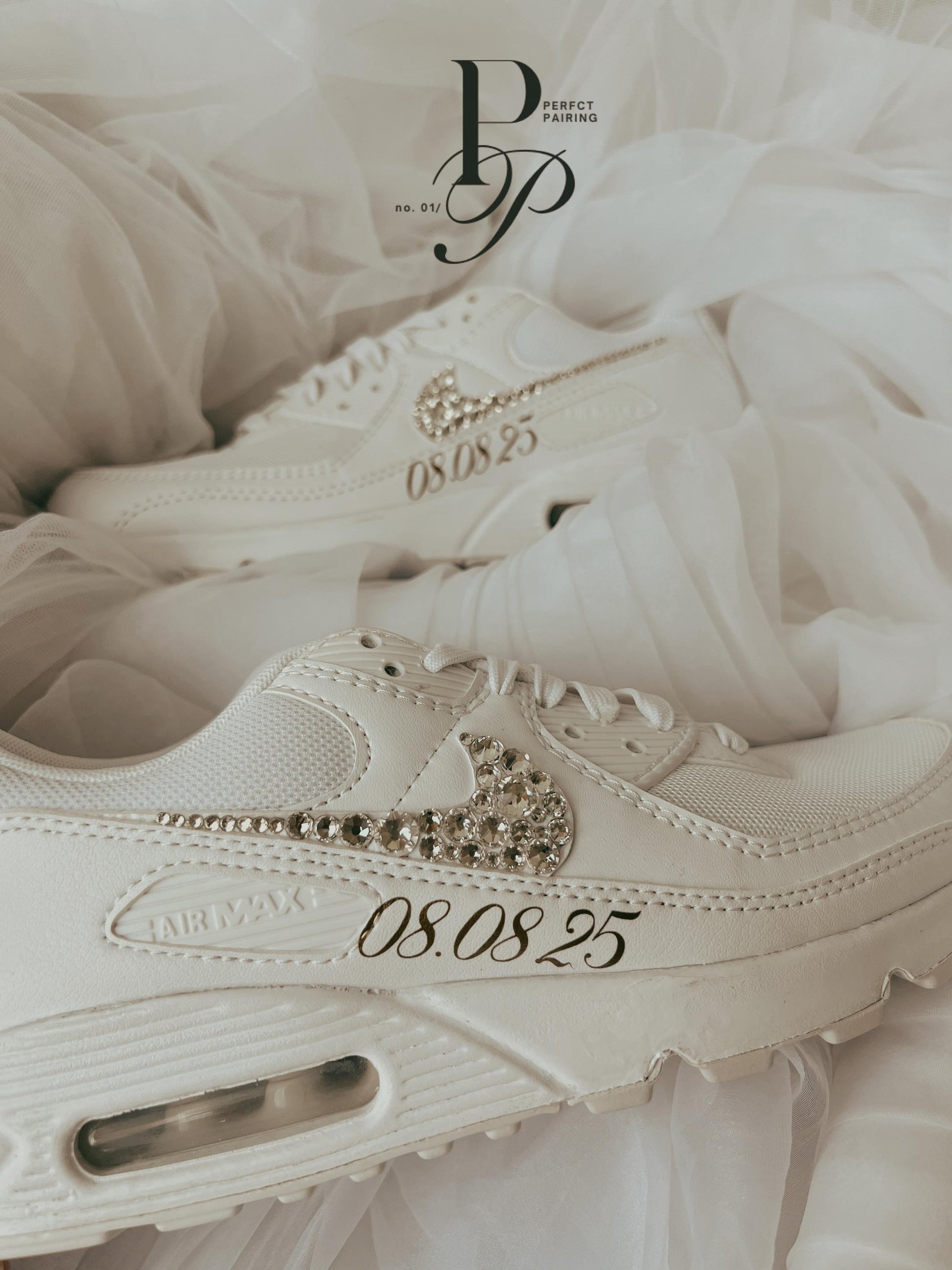 Side view of white Nike Air Max 90 bridal sneakers decorated with sparkling rhinestones for a wedding day look.